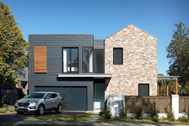 Design ideas for a contemporary two-storey brick black duplex exterior in Sydney.