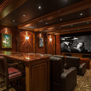 Large mediterranean enclosed home cinema in Orange County with brown walls, carpet, a projector screen and multi-coloured floors.