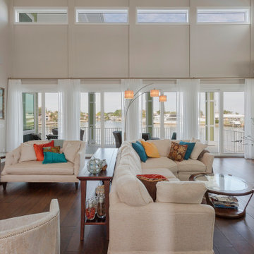 Coastal Living Room with Full-Height Glass and Layered Seating