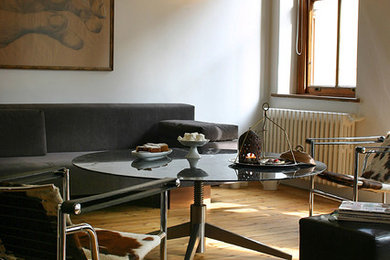 Eclectic medium tone wood floor living room photo in Other with white walls