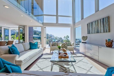 Large beach style formal and open concept medium tone wood floor and brown floor living room photo in Orange County with white walls, no fireplace and no tv