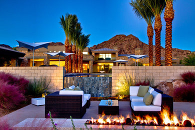 Example of a mid-sized trendy backyard concrete patio design in Phoenix with a fire pit and no cover