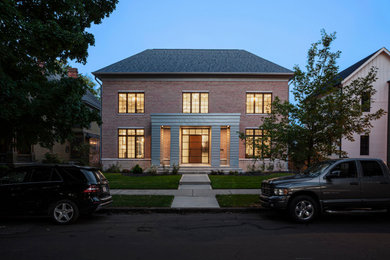 Example of a mid-sized minimalist pink two-story brick house exterior design in Indianapolis with a hip roof, a shingle roof and a gray roof