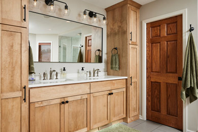 Photo of a large contemporary master bathroom in Minneapolis with shaker cabinets, light wood cabinets, a freestanding tub, a corner shower, a one-piece toilet, beige walls, ceramic floors, an undermount sink, engineered quartz benchtops, grey floor, a hinged shower door, white benchtops, a niche, a double vanity and a built-in vanity.