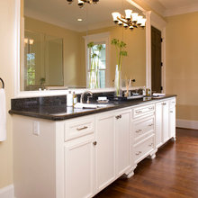 white vanity with black granite countertop