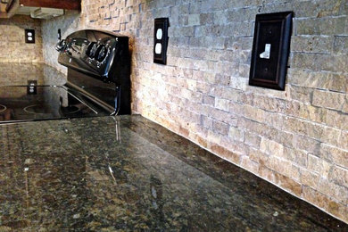 Mid-sized trendy light wood floor open concept kitchen photo in Kansas City with a double-bowl sink, recessed-panel cabinets, dark wood cabinets, granite countertops, gray backsplash, stone tile backsplash and an island