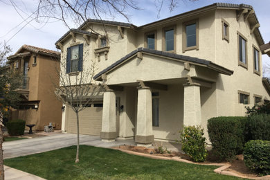 Large craftsman beige two-story stucco exterior home idea in Phoenix with a shingle roof