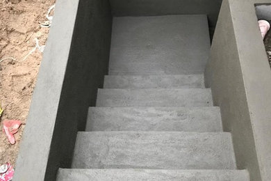 Basement - modern concrete floor basement idea in New York