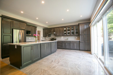 Inspiration for a large contemporary galley ceramic tile, multicolored floor and coffered ceiling open concept kitchen remodel in Montreal with a double-bowl sink, shaker cabinets, gray cabinets, quartzite countertops, gray backsplash, porcelain backsplash, stainless steel appliances, an island and multicolored countertops