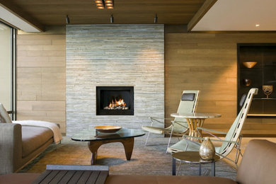 Mid-sized contemporary open concept living room in Los Angeles with beige walls, a standard fireplace, a tile fireplace surround, no tv and beige floor.