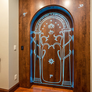 Inspiration for a medium sized contemporary enclosed home cinema in Other with beige walls, dark hardwood flooring, a projector screen and brown floors.