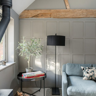 Inspiration for a large rural enclosed living room in Other with grey walls and a wood burning stove.