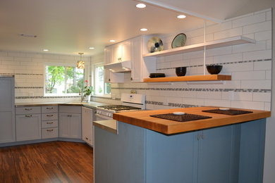 Example of a trendy bamboo floor kitchen design in Other with an undermount sink, white backsplash, ceramic backsplash and white appliances