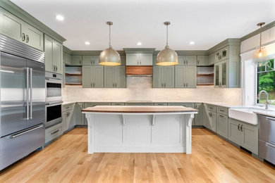 Transitional kitchen photo in Boston with shaker cabinets, green cabinets, quartz countertops, an island and white countertops