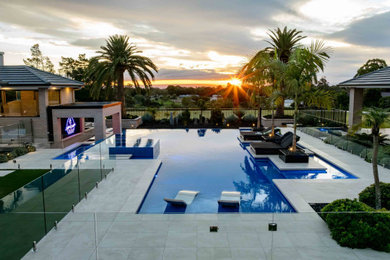 Photo of a tropical backyard custom-shaped pool in Sydney.