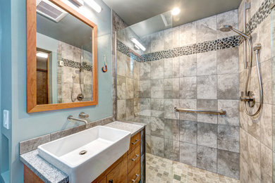 Mid-sized modern master bathroom in Portland with flat-panel cabinets, medium wood cabinets, an alcove shower, black tile, pebble tile, a two-piece toilet, grey walls, ceramic floors and an undermount sink.