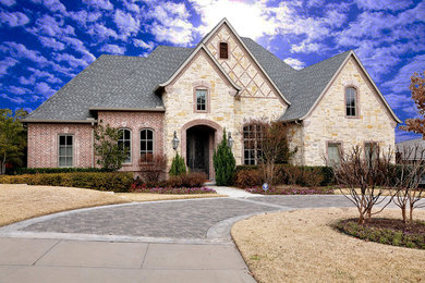 Example of a huge classic one-story stone exterior home design in Dallas