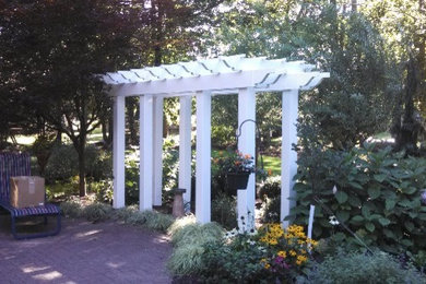 Inspiration for a large traditional partial sun backyard brick formal garden in Cleveland.