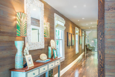Example of a large beach style dark wood floor and brown floor hallway design in Miami with brown walls