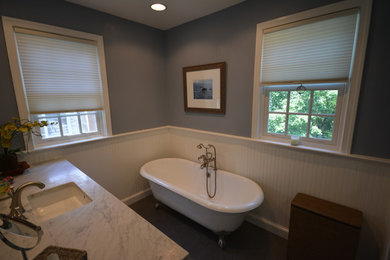 Example of a mid-sized minimalist master white tile and stone slab ceramic tile bathroom design in DC Metro with an undermount sink, raised-panel cabinets, white cabinets, marble countertops, a two-piece toilet and gray walls