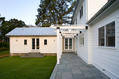Large transitional white two-story exterior home idea in Other