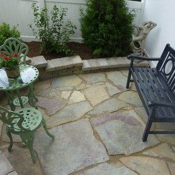 Brussels patio and Quarrystone walls in small courtyard