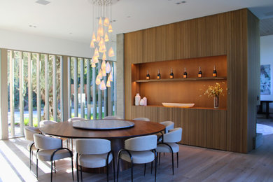 Large minimalist light wood floor great room photo in San Francisco with white walls, a corner fireplace and a wood fireplace surround