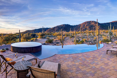 Pool fountain - mid-sized contemporary backyard brick and custom-shaped infinity pool fountain idea in Phoenix
