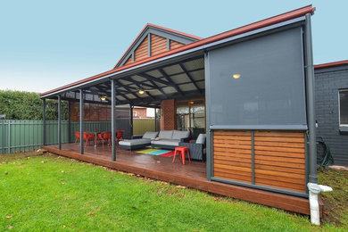 This is an example of a large contemporary backyard patio in Adelaide with decking and a pergola.