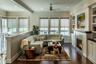 Inspiration for a mid-sized transitional formal and enclosed dark wood floor and brown floor living room remodel in Chicago with white walls, a standard fireplace, a stone fireplace and a wall-mounted tv