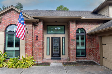 Example of a large classic brown two-story concrete fiberboard and clapboard exterior home design in Houston with a shingle roof and a gray roof