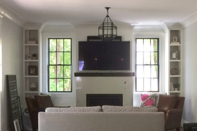 Example of a transitional living room design in Boston with a bar, a standard fireplace and a wall-mounted tv