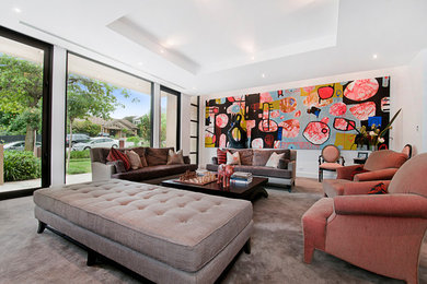 Expansive contemporary formal open concept living room in Melbourne with white walls and carpet.