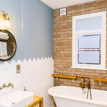 A rustic bathroom with a rolltop bath