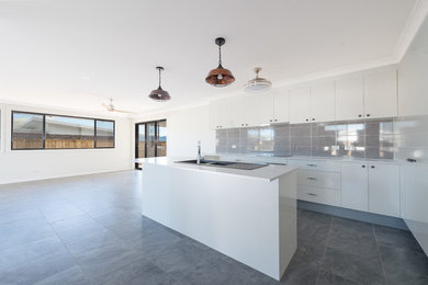 Inspiration for a contemporary kitchen in Melbourne with a double-bowl sink, granite benchtops, ceramic splashback and ceramic floors.