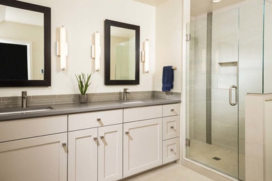 Inspiration for a mid-sized transitional master beige tile and porcelain tile porcelain tile and beige floor alcove shower remodel in Other with an undermount sink, shaker cabinets, beige cabinets, quartz countertops, a one-piece toilet, white walls and a hinged shower door