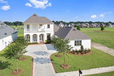 Mid-sized transitional white two-story brick exterior home idea in New Orleans