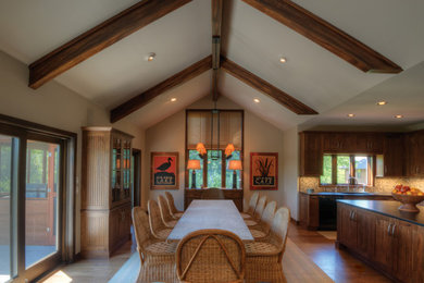 Inspiration for a huge timeless medium tone wood floor eat-in kitchen remodel in Wichita with an undermount sink, granite countertops, beige backsplash, stone tile backsplash, black appliances, an island and dark wood cabinets