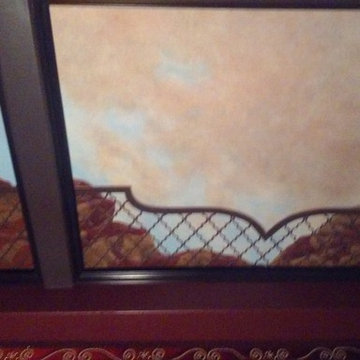 Mural of Moroccan sunset on coffered ceiling in home theater