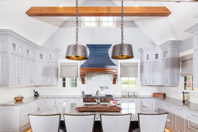 Inspiration for a classic u-shaped kitchen in Charlotte with a submerged sink, raised-panel cabinets, grey cabinets, white splashback, stainless steel appliances, medium hardwood flooring, an island, brown floors, grey worktops, exposed beams and a vaulted ceiling.