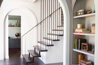 Inspiration for a contemporary hallway in Austin with white walls and dark hardwood floors.