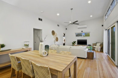 Design ideas for a large beach style open plan dining in Geelong with white walls, light hardwood floors and vaulted.