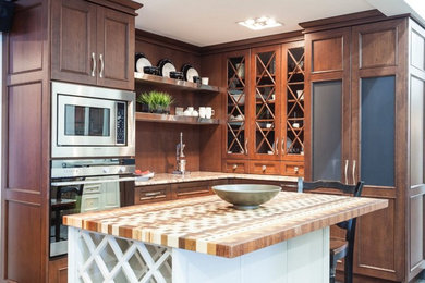 Small transitional l-shaped porcelain tile kitchen photo in Toronto with recessed-panel cabinets, brown cabinets, marble countertops, brown backsplash, stainless steel appliances and an island