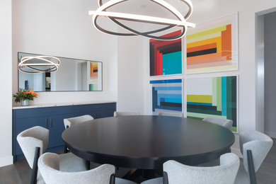 Example of a large transitional dark wood floor and gray floor kitchen/dining room combo design in Calgary with white walls and no fireplace