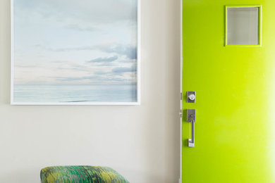 Example of a small trendy dark wood floor entryway design in San Francisco with beige walls and a green front door