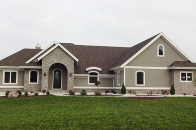 Mid-sized traditional beige two-story mixed siding gable roof idea in Other