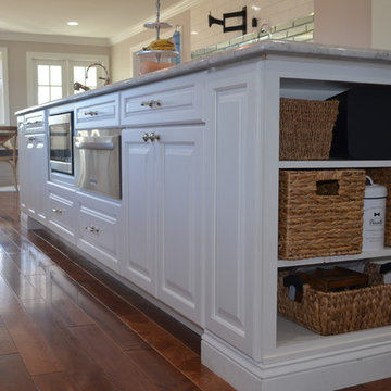 Traditional Spacious White Kitchen with Custom Island and Booth