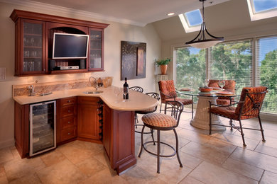 Elegant porcelain tile wet bar photo in Philadelphia with an undermount sink, raised-panel cabinets, medium tone wood cabinets, quartzite countertops and beige countertops