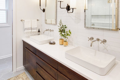 Example of a large trendy master white tile and porcelain tile porcelain tile and gray floor bathroom design in Chicago with flat-panel cabinets, dark wood cabinets, white walls, a drop-in sink and quartz countertops