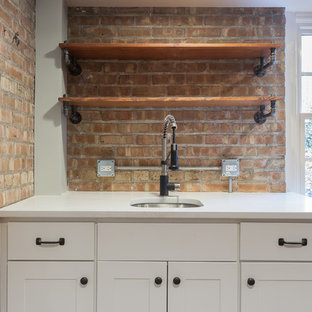 Large urban walk-out basement in Chicago with blue walls, laminate floors, a standard fireplace, a wooden fireplace surround and brown floors.